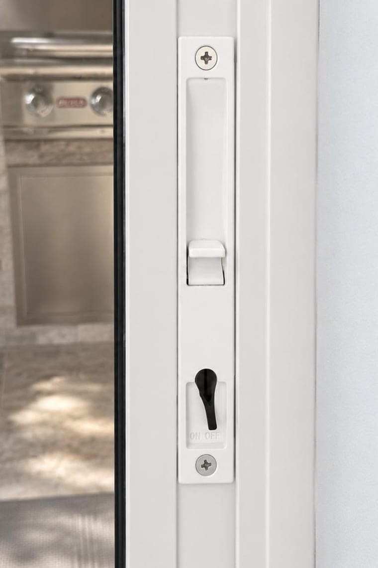 Before — White flush sliding door handle with a keyed lock lever